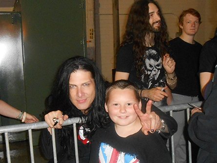 Ten-year-old JJ Whitten, of Milford, has already been to dozens of concerts with his parents Jess and Sue. Here he is pictured with bassist Todd Kerns, of Myles Kennedy and the Conspirators