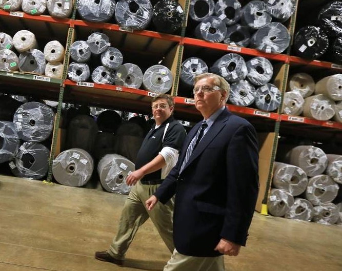 South Carolina Senator and GOP presidential candidate Lindsey Graham walks alongside Foss Manufacturing Chief Operating Officer Bill Cummings