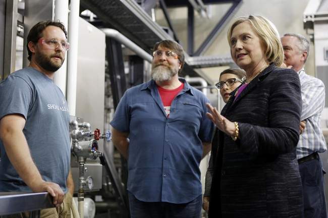 Democratic presidential candidate Hillary Rodham Clinton speaks with employees during a tour of the Smuttynose Brewery on Friday in Hampton. [Jim Cole photo]