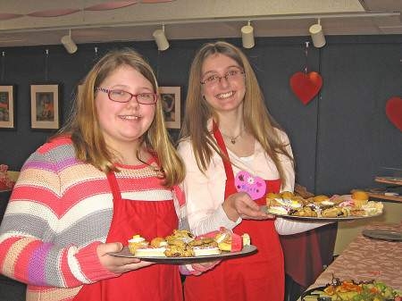 Hampton Academy students Macy Fraser and Mya Sanders volunteered to help out at this year’s Valentine Tea
