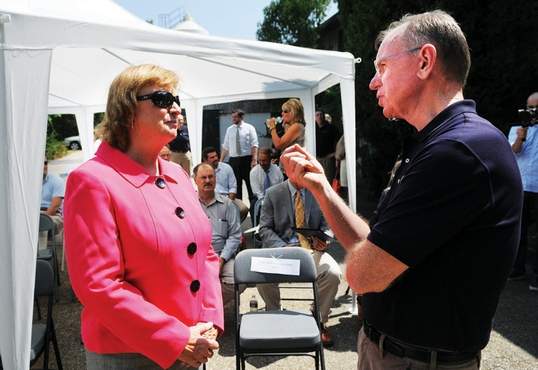 Congresswoman Carol Shea-Porter, D-N.H., speaks with Peter Melendy, owner of Adhesive Technologies Inc. in Hampton before an official ribbon-cutting ceremony.