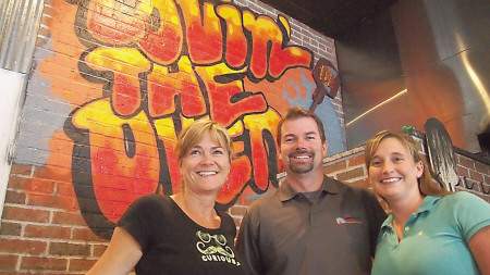 Shane Pine, owner of The Community Oven in Hampton, center, has helped raise more than $60,000 for charity this year as part of the restaurant’s “Community Monday” fund-raisers. 