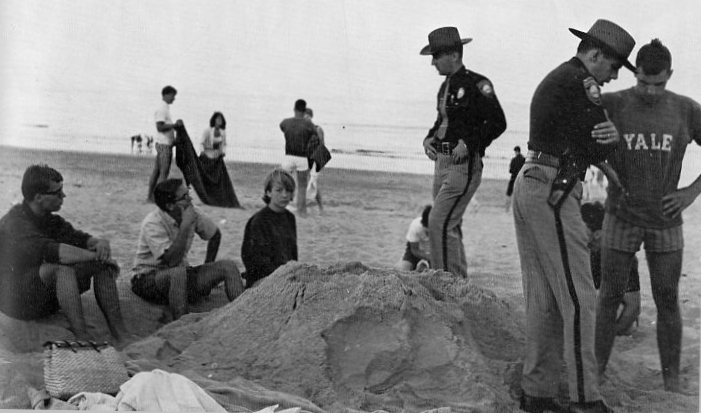 Police chat casually with youth on sand
