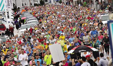 Some of the more than 5000 runners take off at the start of the Smuttynose Rockfest Marathon in Hampton Beach on Sunday. 