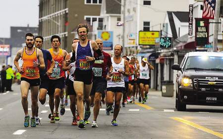 The first wave of runners hit the 1-mile mark during Sunday Smuttynose Rockfest Marathon at Hampton Beach on Sunday. 